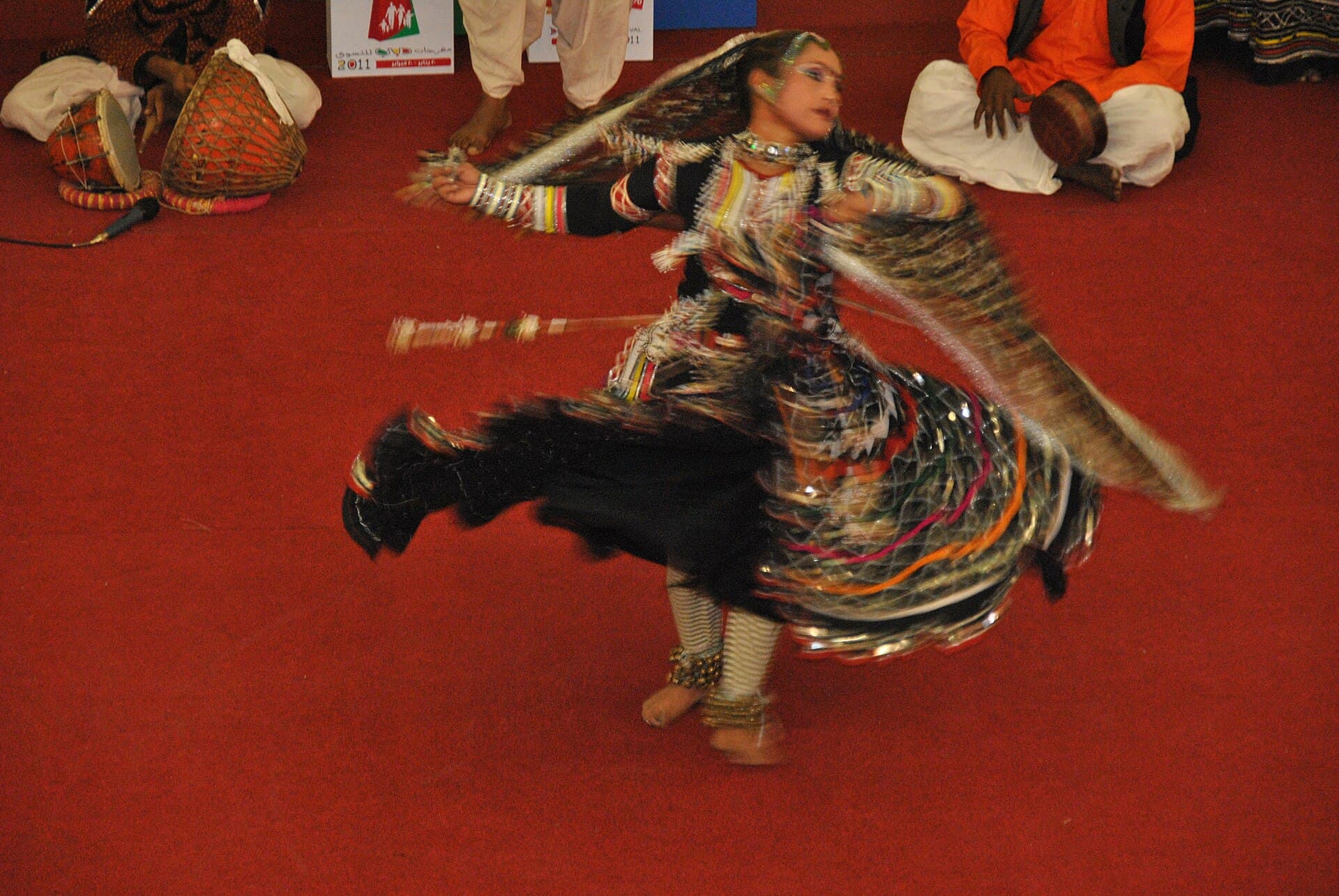 A Kalbeliya folk dancer performing in a swirling black costume